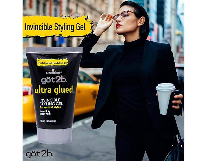 Got2b Glued Spiking Glue product packaging, a black tube labeled 'ultra glued,' next to a woman with short, slicked-back d...