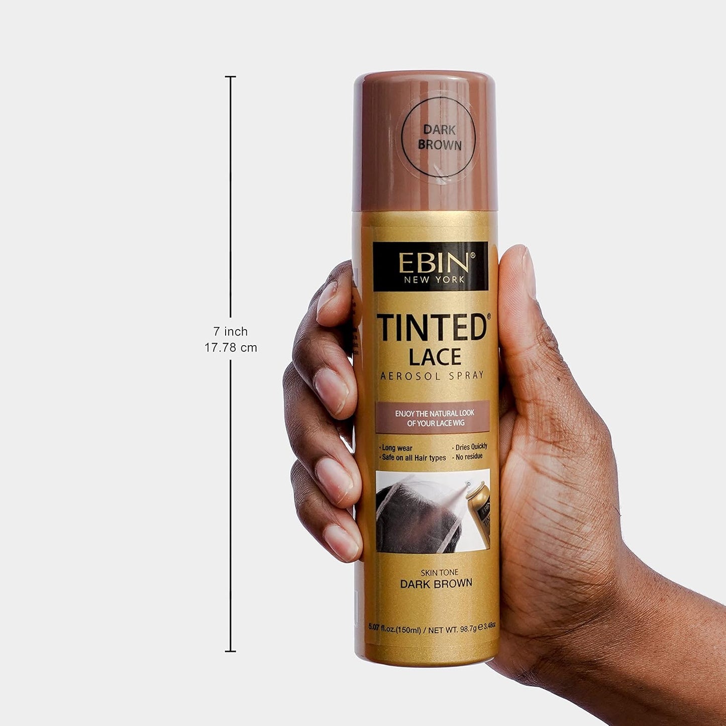 A hand holds the 7-inch EBIN Tinted Lace Aerosol Spray in Dark Brown. The can is gold with a dark brown cap and label.