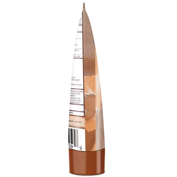 Side view of Ambi Skincare Even & Clear Exfoliating Wash pouch. Brown and tan skin tone gradient design with visible text ...