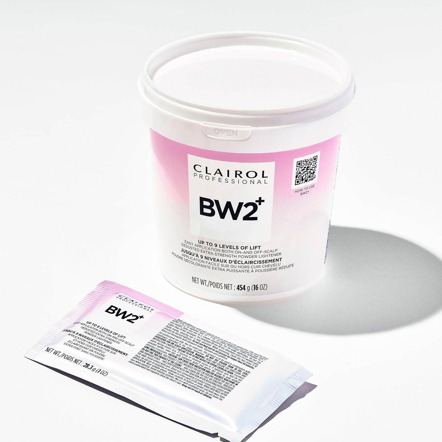 Packaging for Clairol Professional BW2+ Dedusted Extra Strength Powder Lightener: a white tub with a pink label and a smal...