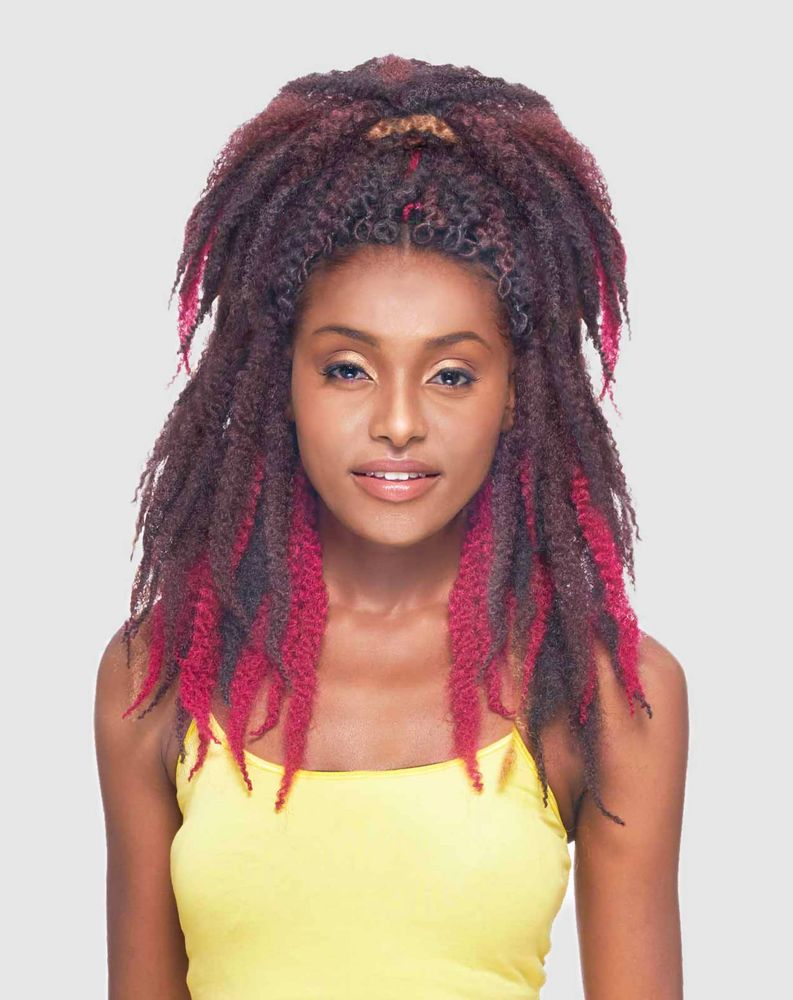 Woman wearing voluminous Synthetic Afro 3 kinky braiding hair. Medium length, dark reddish-brown with vibrant pink ends.