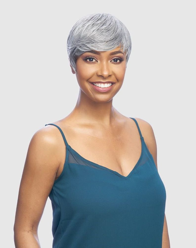 A smiling woman wears the Vanessa AKSA Synthetic Wig, a short, silver pixie style with swept bangs.