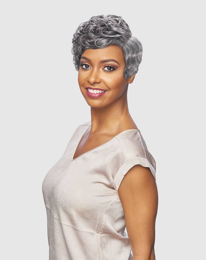 Smiling woman wearing DRJ JESLI synthetic lace wig, short grey pixie with tight curls and finger waves.