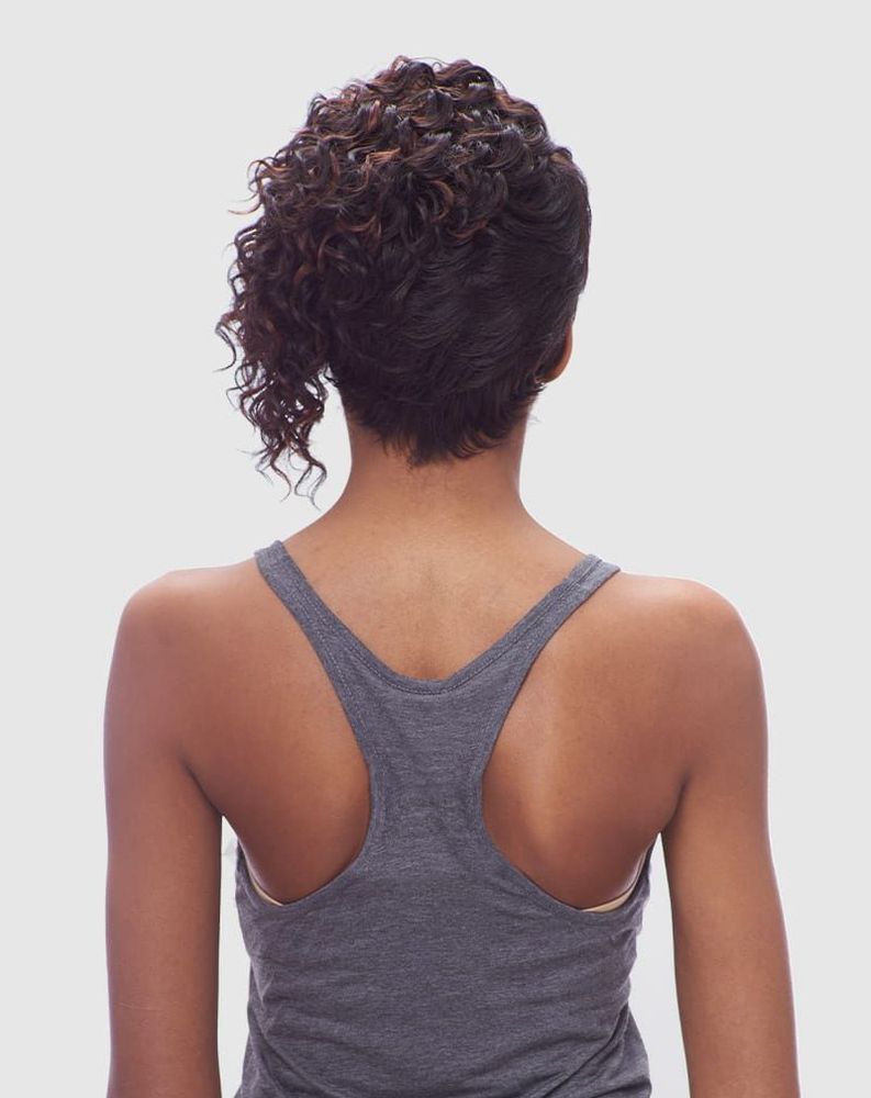 Back view of a person wearing the Vanessa HELTY wig. Short, dark brown curly hair with highlights, styled asymmetrically w...