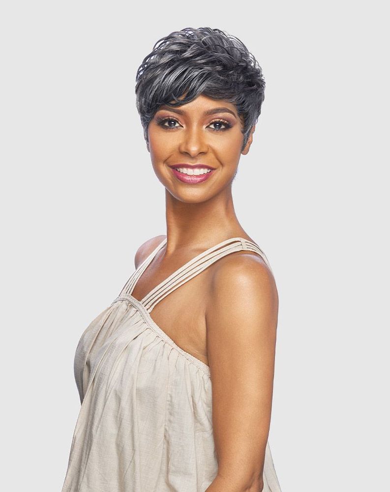 Smiling woman models the Vanessa TANDY Quick Style wig, a short, wavy, multi-tonal gray pixie.