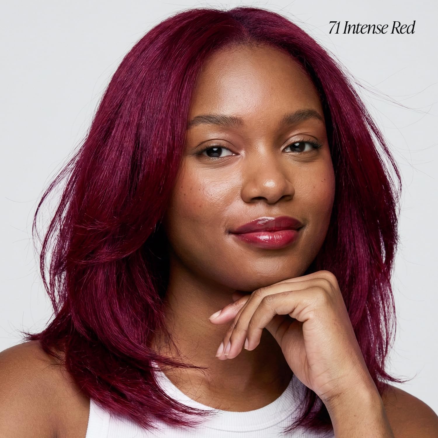 Smiling woman with shoulder-length, vibrant Creative Image Adore #071 Intense Red hair.