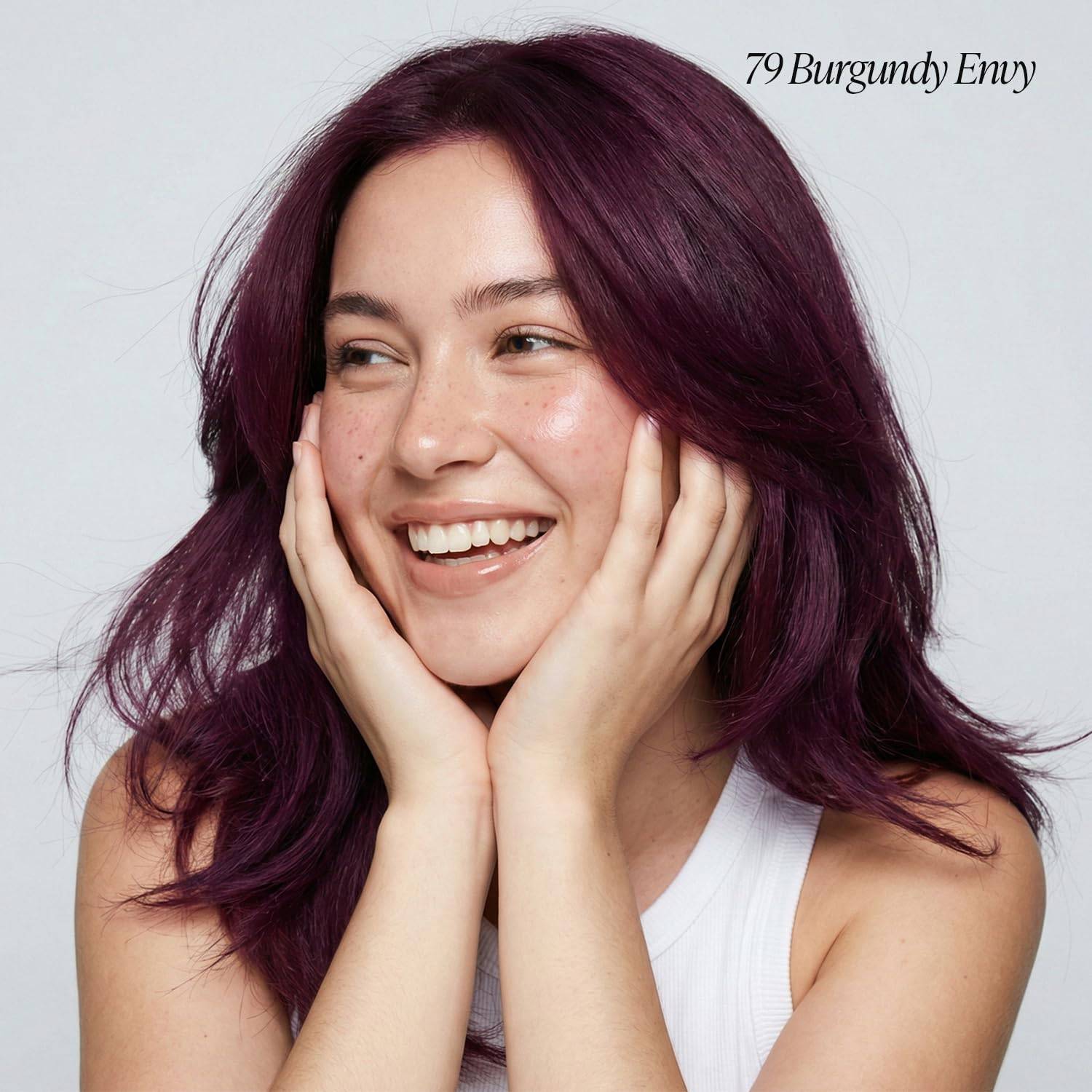 Smiling woman with shoulder-length, loose hair in Creative Image Adore #79 Burgundy Envy, a deep purple-red shade.