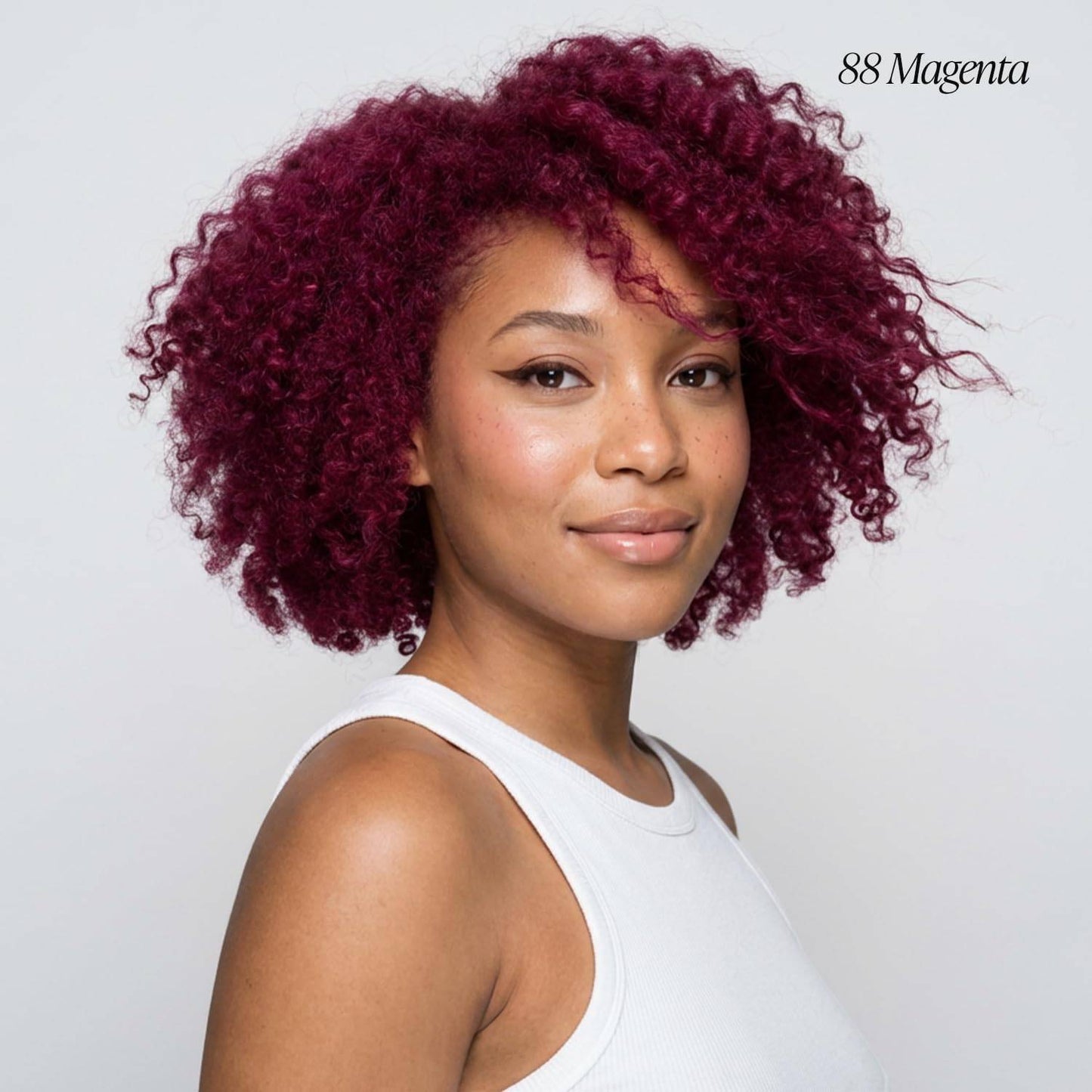 Creative Image Adore #88 Magenta. A smiling woman with short, voluminous, vivid magenta curly hair.