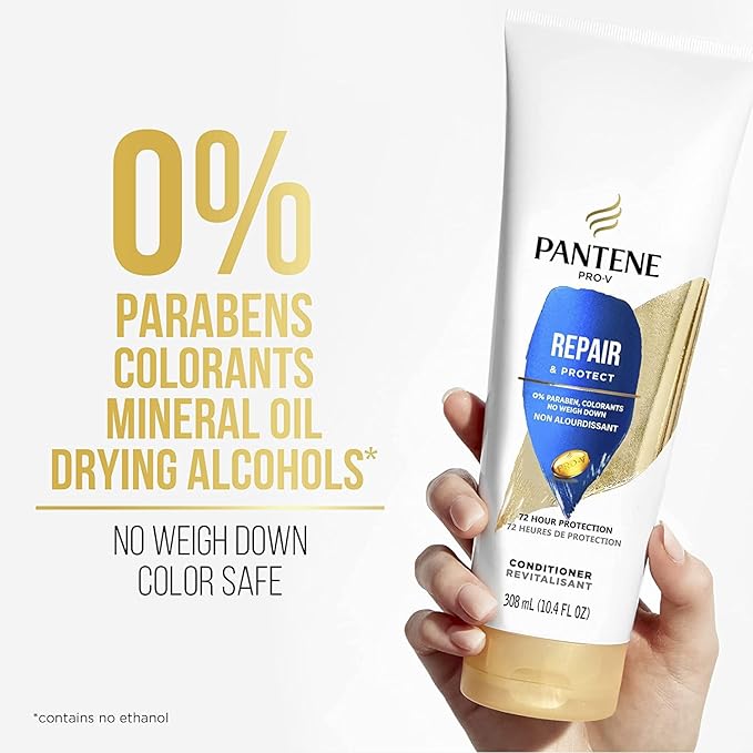 Hand holds Pantene Pro-V Repair & Protect Conditioner, 10.4 oz tube. White packaging with blue/gold label, plus "0% Parabe...