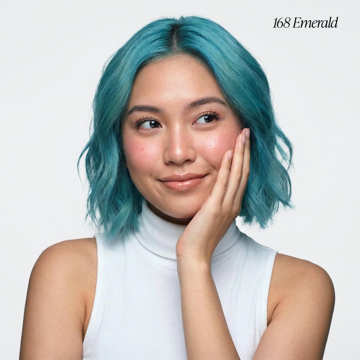 Young woman with Creative Image Adore #168 Emerald semi-permanent hair color. She has a chin-length wavy teal bob.
