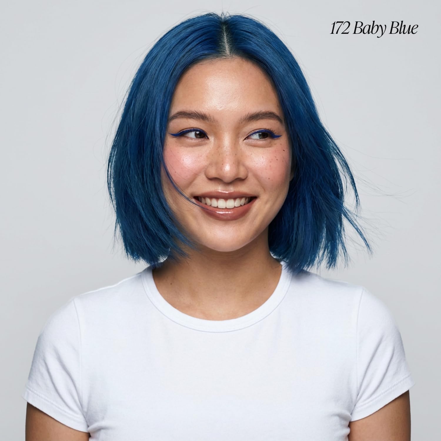 Woman wearing Creative Image Adore #172 Baby Blue semi-permanent hair color. Short bob, windblown.