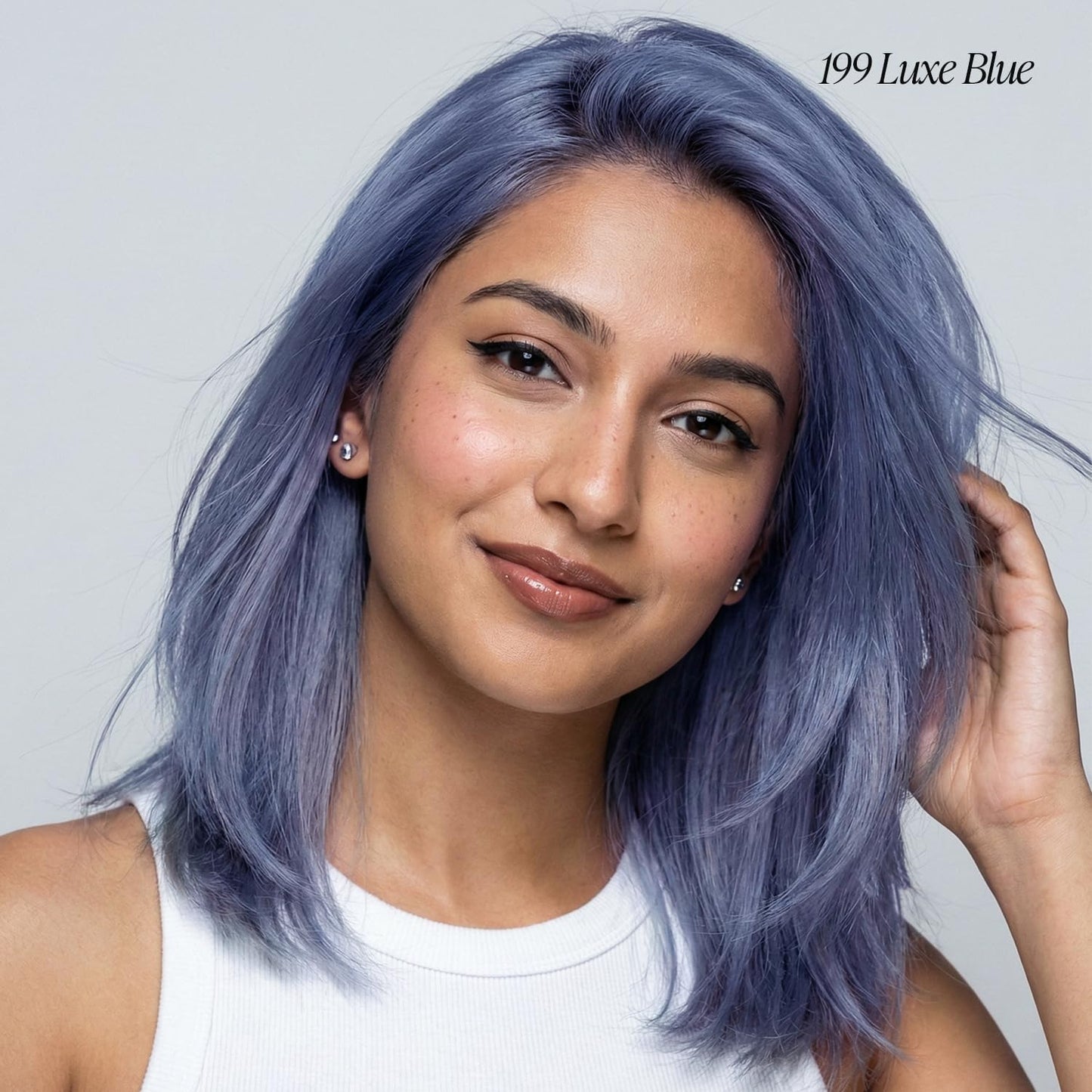 Smiling woman with straight, shoulder-length Creative Image Adore #199 Luxe Blue hair, a soft dusty blue shade.