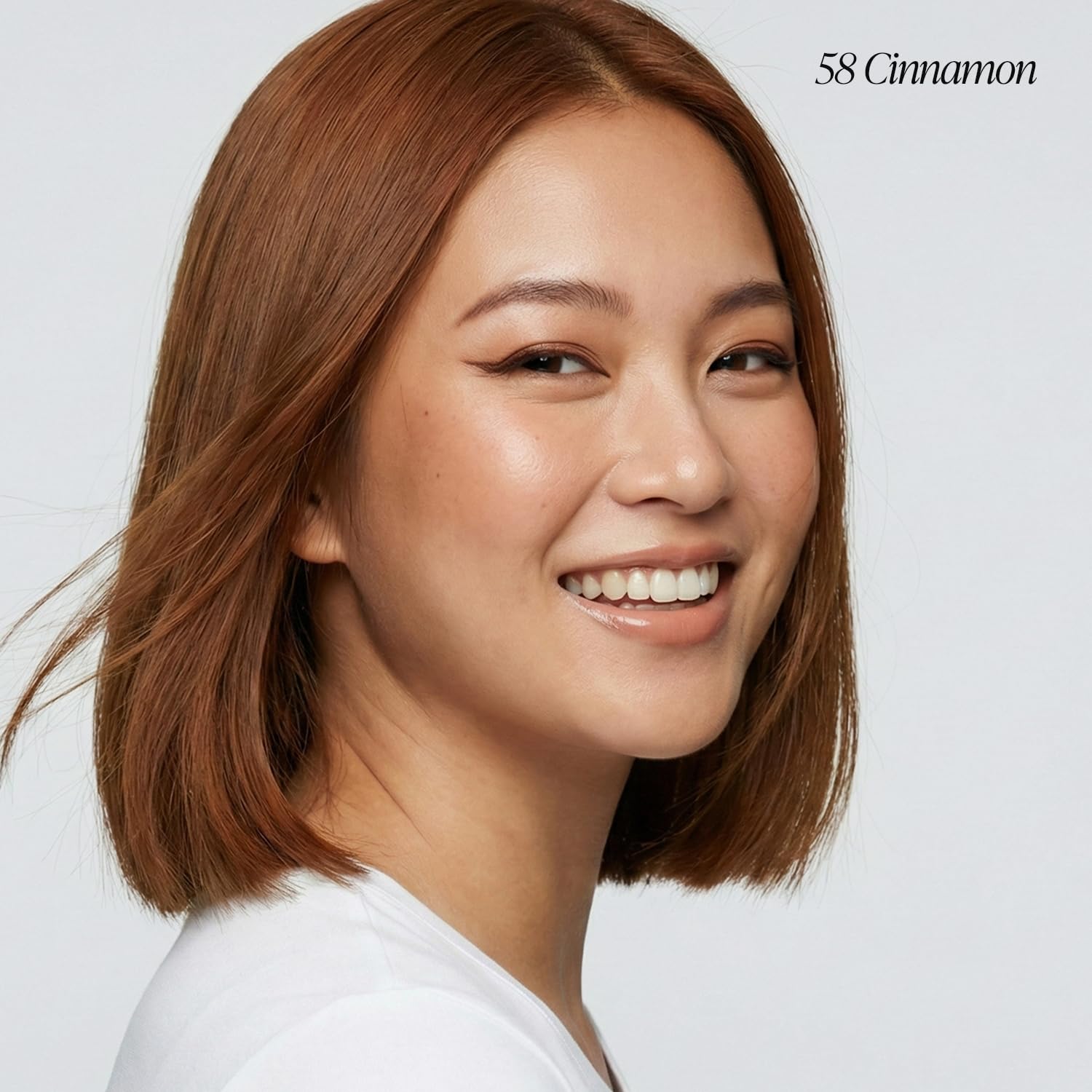 Smiling woman with a sleek, straight bob models Creative Image Adore #058 Cinnamon semi-permanent hair color.