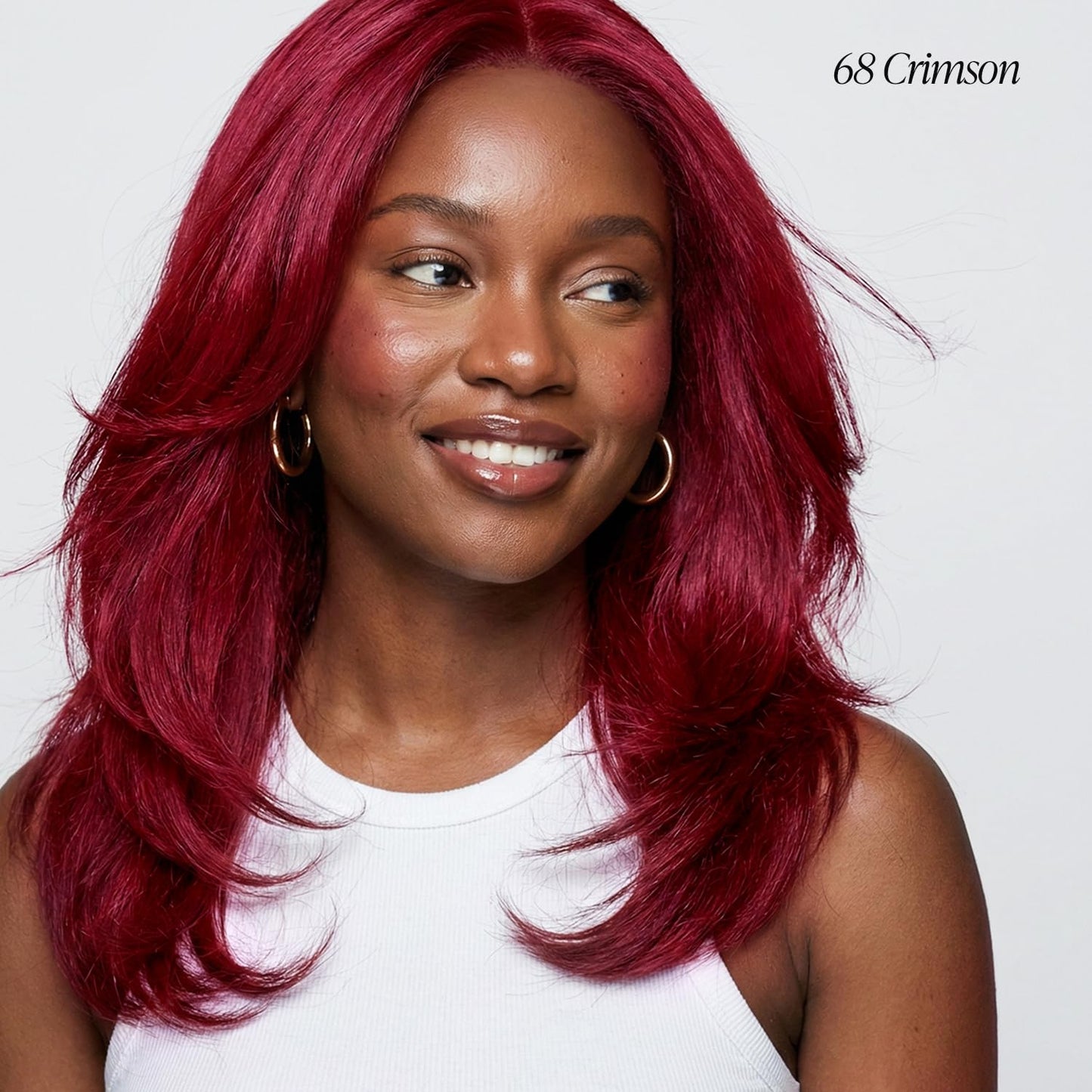 Smiling woman with voluminous, layered medium-length hair in Creative Image Adore #068 Crimson.