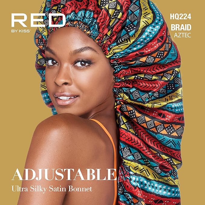 Smiling woman wearing a RED By Kiss Adjustable Ultra Silky Satin Bonnet. It features a long, colorful Aztec pattern.