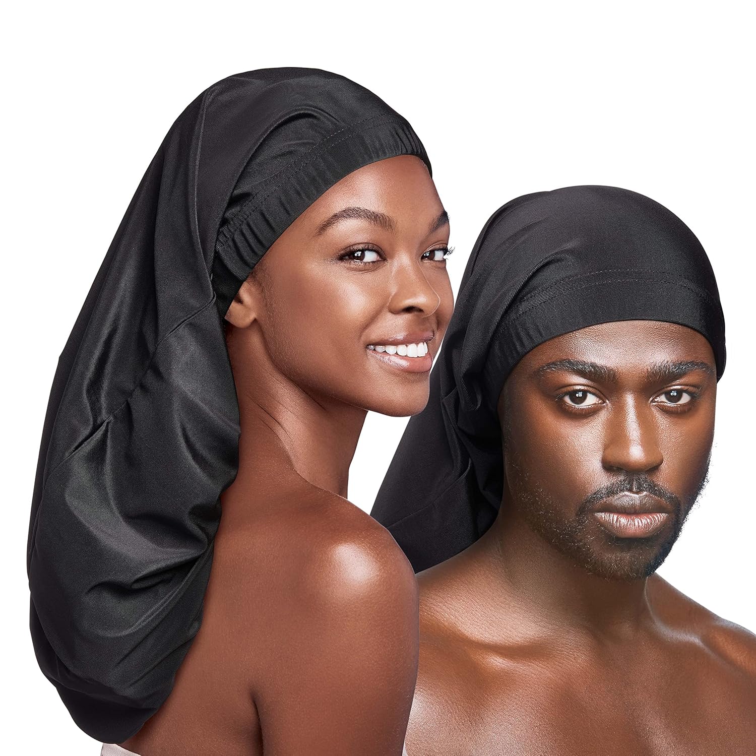 A smiling woman models the long RED By Kiss Super Jumbo black silky spandex loc cap, next to a man wearing a similar cap.