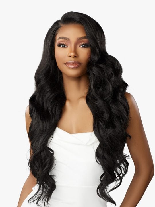 Woman wearing a Bare Lace Full Lace Unit 8 wig. She has long, voluminous black wavy hair with a side part.