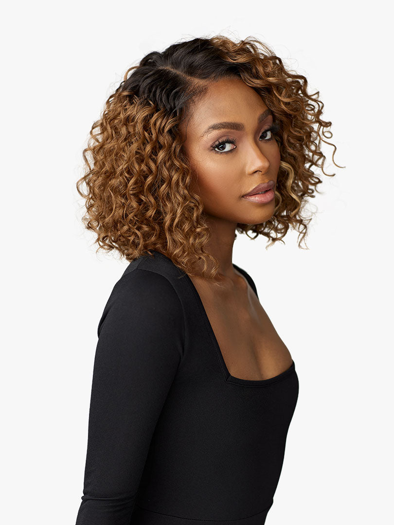 Woman wearing Butta Chic Bob Lace Wig - LOB Unit 3, a voluminous, short curly ombre bob with dark roots and golden highlig...