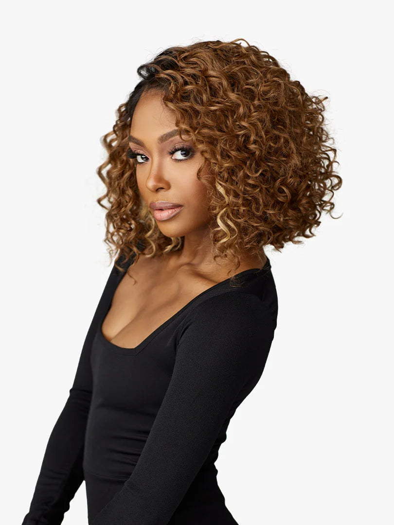 Woman models Butta Chic Bob Lace Wig LOB Unit 3: a voluminous, chin-length curly bob in brown with blonde highlights.