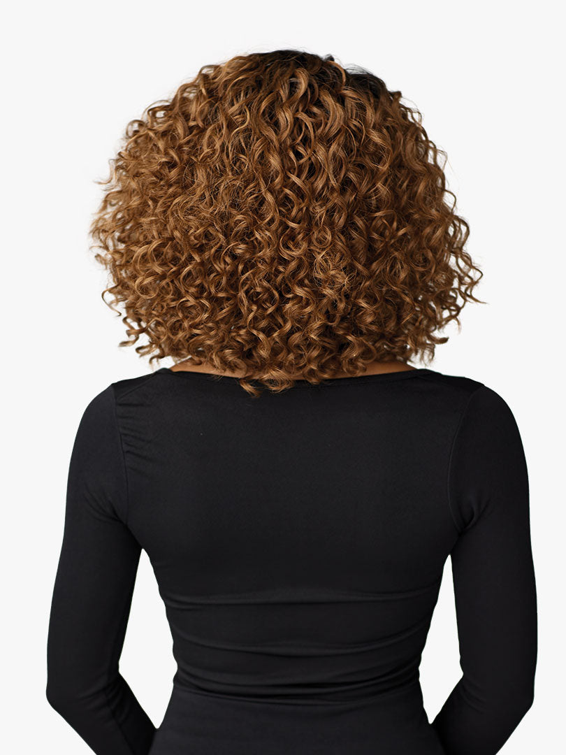 Back view of a person wearing the Butta Chic Bob Lace Wig, a shoulder-length curly bob in warm brown with highlights.