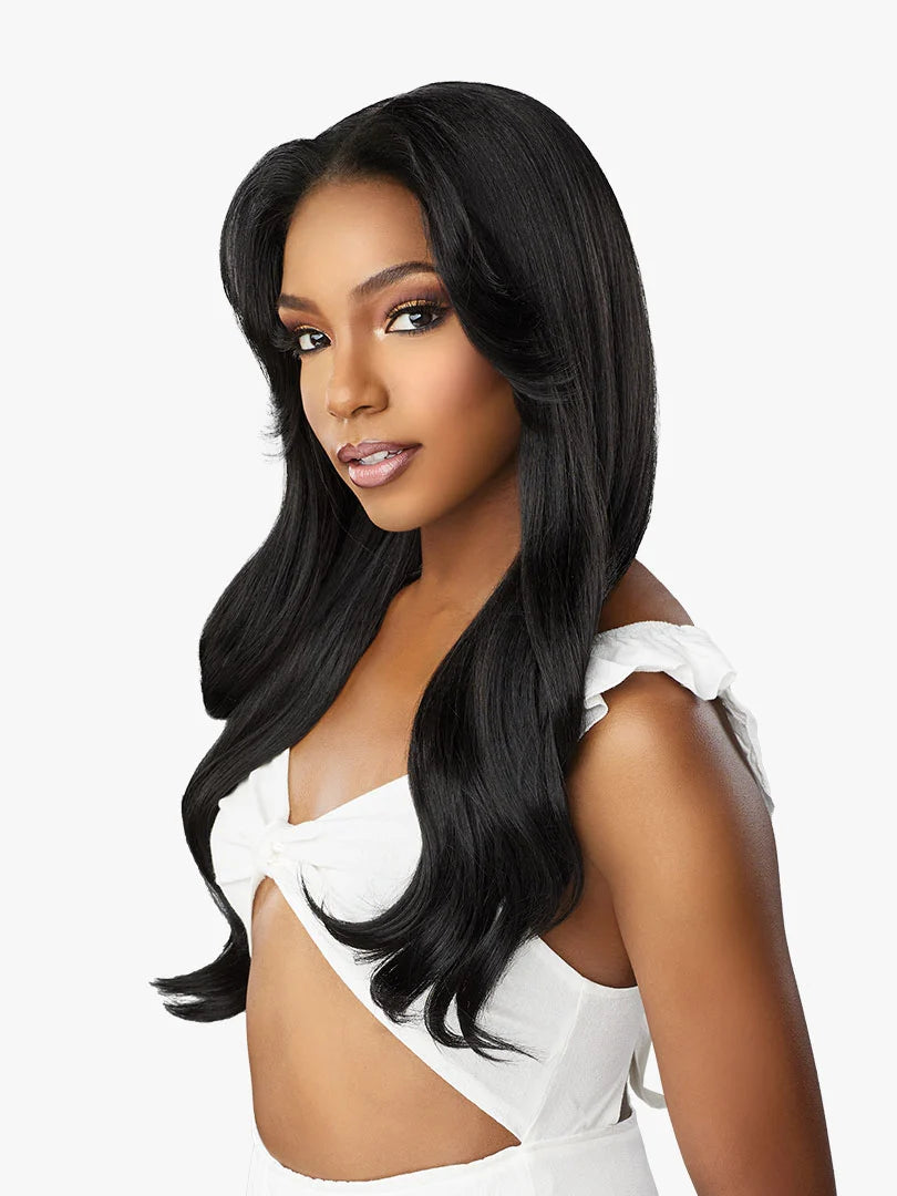 Dashly Lace Wig - Unit 27. Woman with a side part, wearing a long, layered black wig with voluminous, face-framing waves.