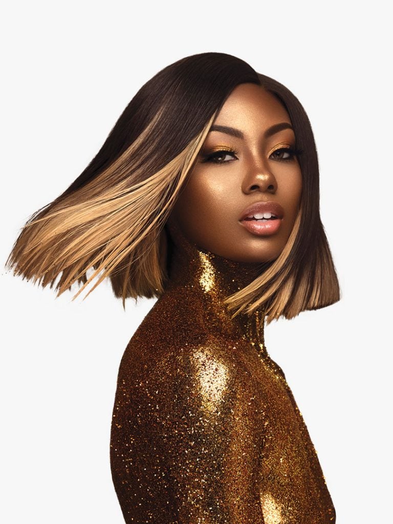 Woman wearing HH YAKI WVG 12 (EMPIRE GOLD) bob wig. It's a sleek, straight dark brown bob with bold blonde highlights, sty...