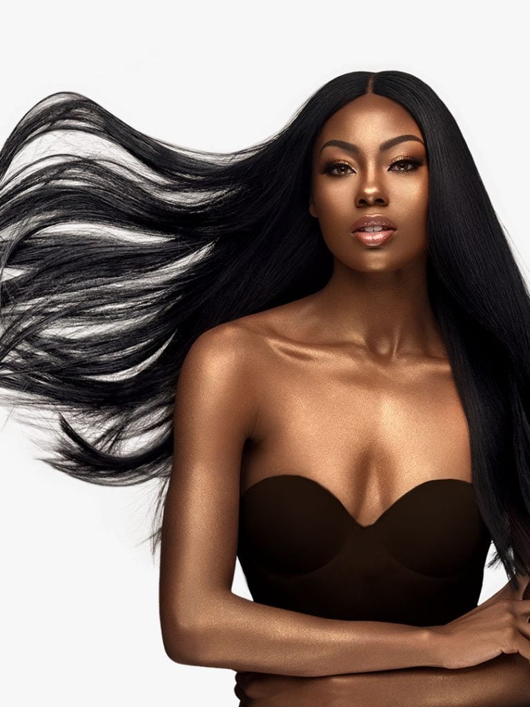 Woman models HH YAKI WVG 12, long straight black hair with a center part, flowing dramatically.