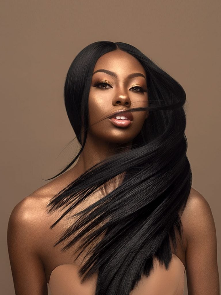 Woman modeling HH YAKI WVG 12, long sleek black hair, center-parted and flowing dynamically.
