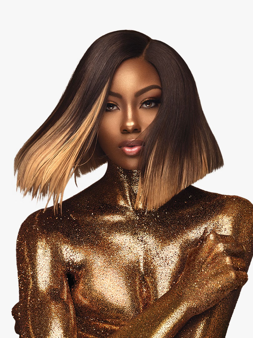 Woman models HH YAKI WVG 12 (EMPIRE GOLD) short, sleek, chin-length bob. Dark brown hair ombre to golden blonde.