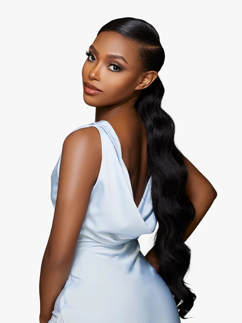 Woman models GLAMORA Glam Updo Unit 6: a sleek, deep side-parted black wavy ponytail flowing long down her back.