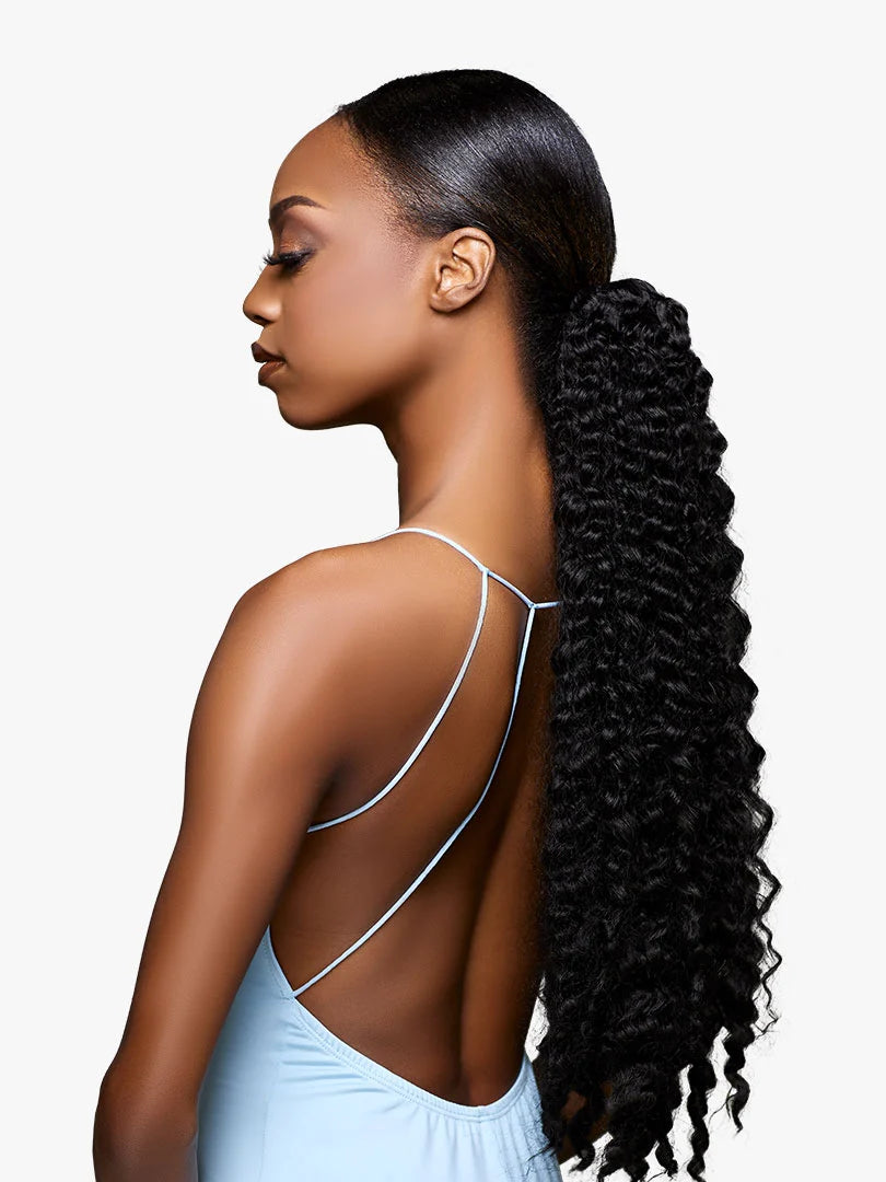 Woman wearing GLAMORA Glam Updo Unit 7, a long, black kinky curly ponytail with sleek pulled-back hair.