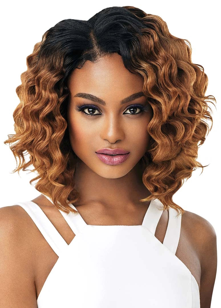 A woman models the Diva Wave style: a wavy, shoulder-length ombre bob with dark roots and caramel brown ends.