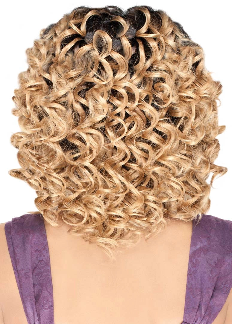 Rear view of a model wearing Purple Pack Twin Deep, a short, voluminous blonde curly style with dark roots.