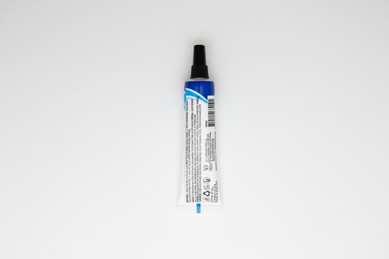 Ebin Wonder Lace Bond Lace Wig Adhesive Tube, a white squeeze tube with a blue label and black nozzle.