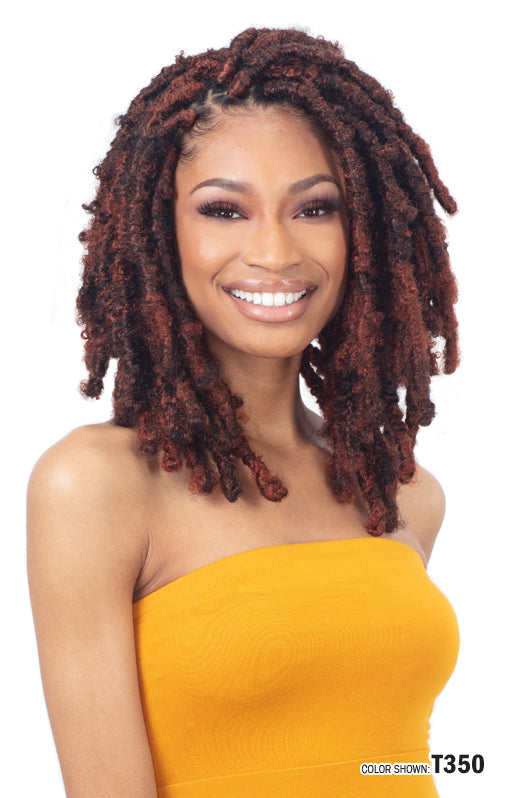 Smiling woman wears Freetress 3X Pre-Fluffed Poppin' Twist 16" hair in thick, reddish-brown, shoulder-length dreadlock twi...