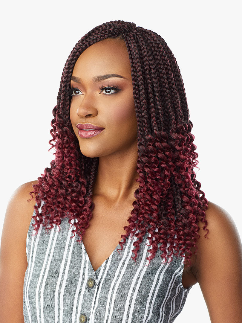 Woman wearing Lulutress 3X Goddess Box Braid 12". Dark burgundy braids transition to vibrant red curly ends.