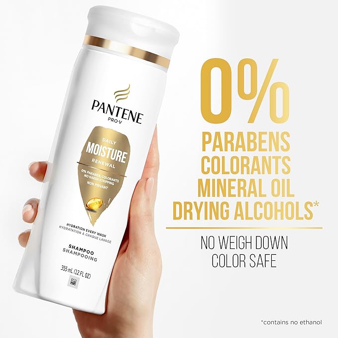 White Pantene Pro-V Daily Moisture Shampoo 12 oz bottle held by a hand. Bold gold text next to it lists 0% parabens.