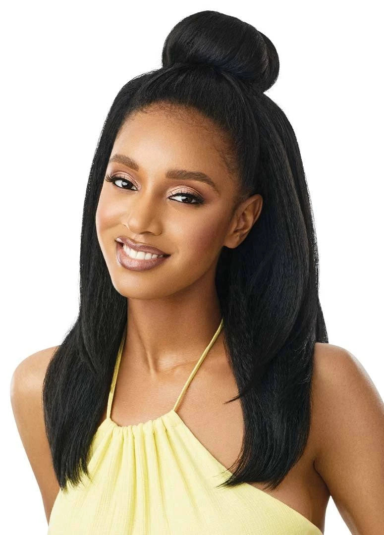 Smiling woman models the Outre Hawaiian Hottie wig, with long black kinky straight hair in a half-up bun.