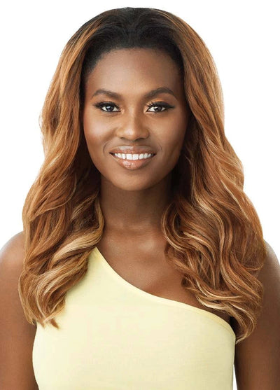 Smiling woman wearing Outre Converti-Cap Rosey Waves half wig. Long, wavy ombre brown hair with blonde highlights.