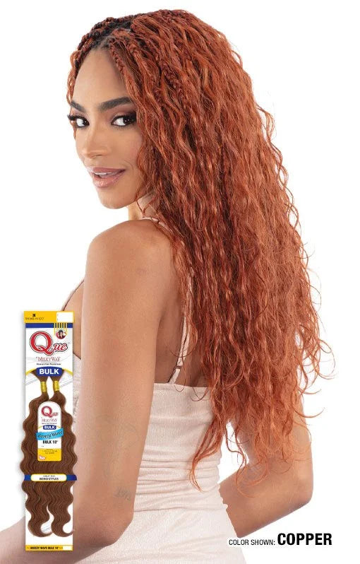 Woman models long, wavy copper Que by Milky Way Breezy Wave hair with braids at the roots. Product packaging shown.
