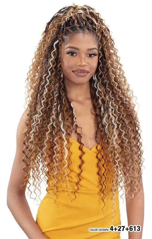 Woman with long, voluminous FREETRESS BOHO DEEP BULK hair, a mix of brown, caramel, and blonde curls with braided roots.