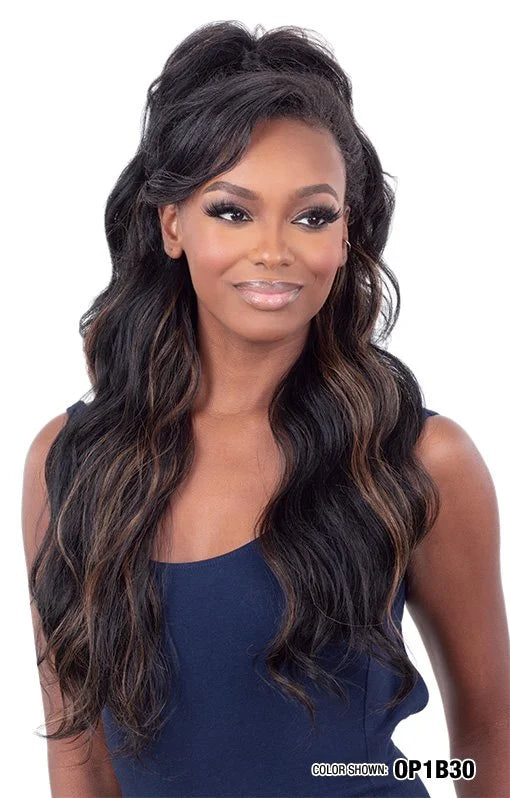 Smiling woman wearing Organique Sun-Kissed Girl wig. Long, wavy black hair with auburn highlights styled half-up, half-down.