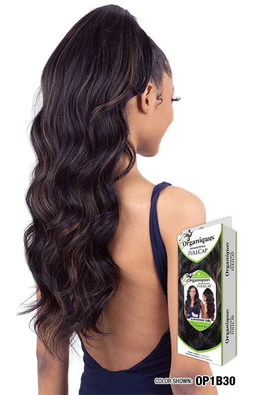 Person wearing Organique Sun-Kissed Girl wig: long, wavy dark brown hair with highlights in a high ponytail. Packaging vis...