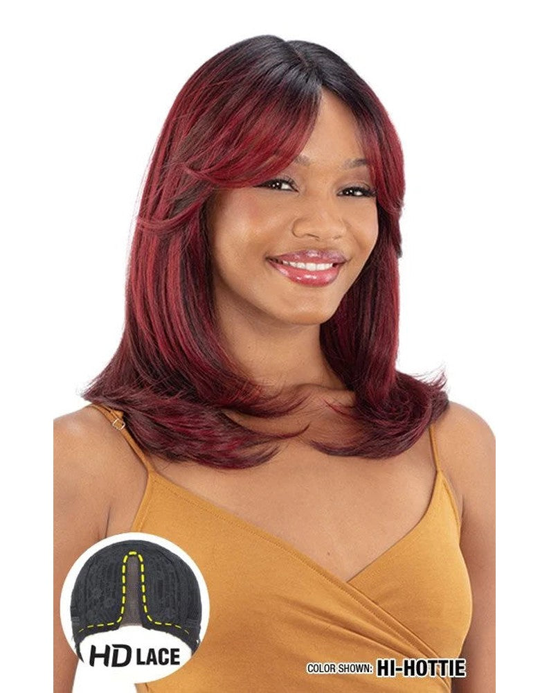 Smiling woman wears Freetress Equal HD Lace Front Wig. Shoulder-length, layered "Hi-Hottie" red wig with curtain bangs.