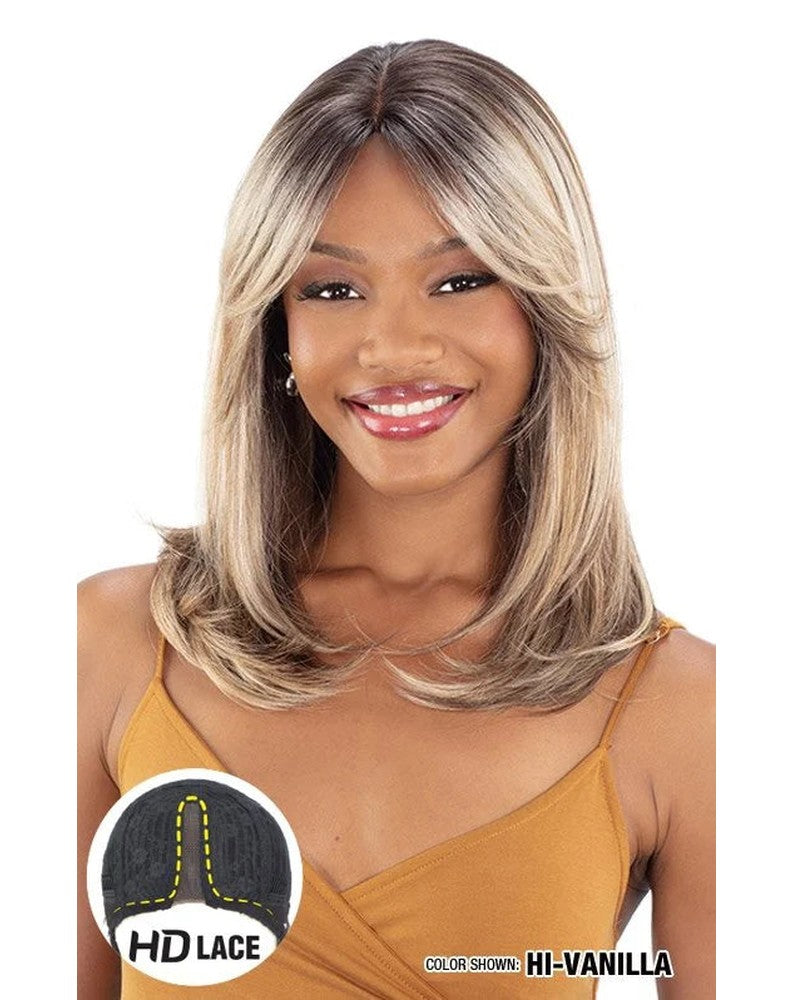 Woman wears Freetress Equal HD Lace Front Wig, HI-VANILLA. Medium layered blonde hair, curtain bangs framing her face.