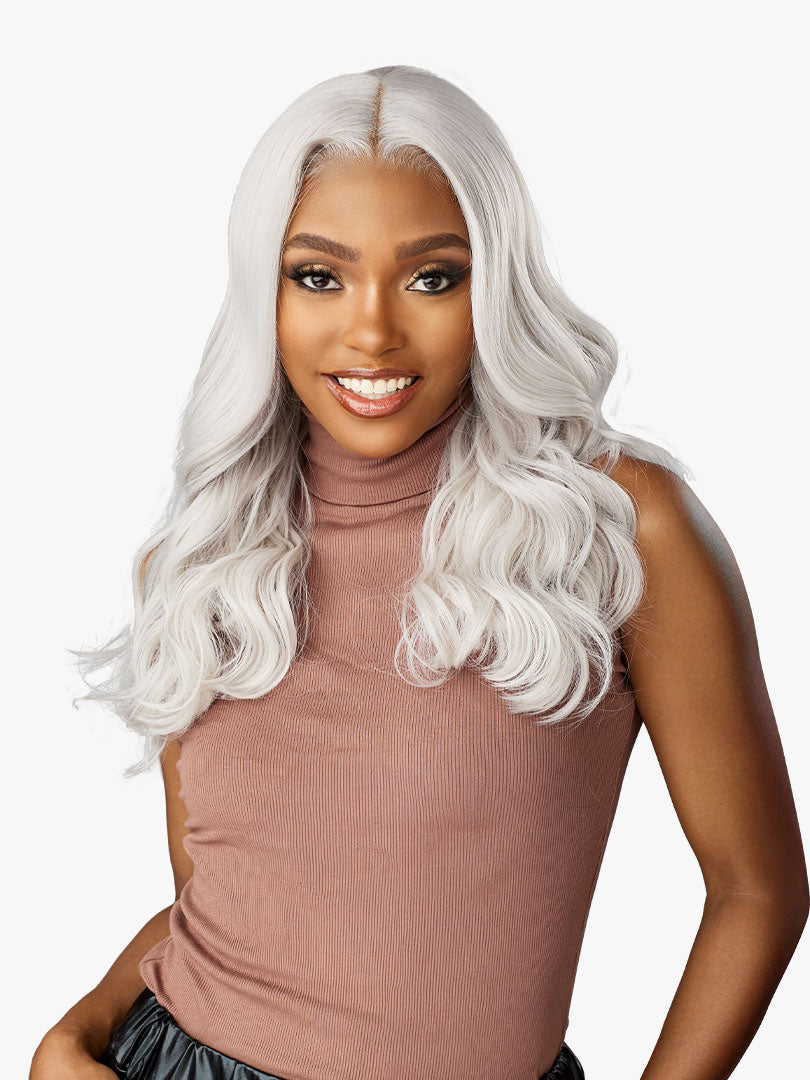 Shear Muse Gold Krush Glueless Lace Front Wig - Lanisha worn by a smiling woman. Long, wavy, platinum blonde hair with a m...