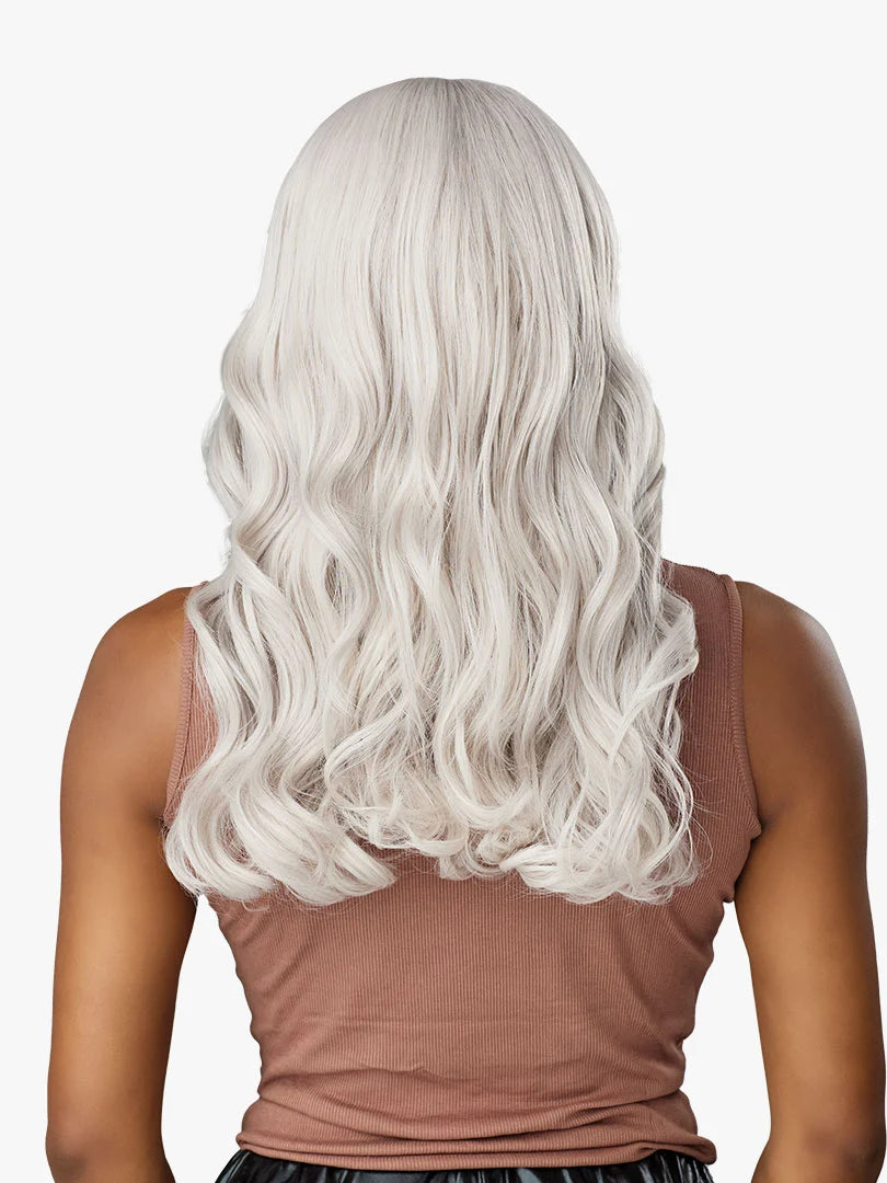 Back view of Shear Muse Gold Krush Lanisha wig: long, wavy platinum blonde hair on a person's shoulders.
