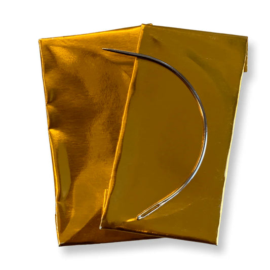BRITTNY DREAM WEAVING NEEDLE CURVE C, a silver curved weaving needle on shiny golden packaging.