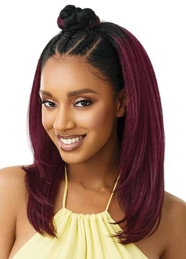 Woman wearing Outre Hawaiian Hottie half wig: straight, layered, shoulder-length burgundy hair with a braided top knot.