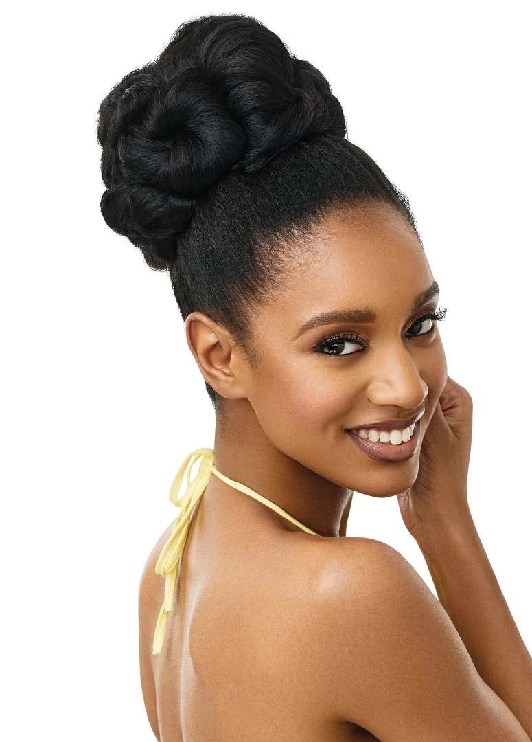 Smiling woman wears the Outre Synthetic Converti-Cap HAWAIIAN HOTTIE half wig, styled in a voluminous, high black bun.